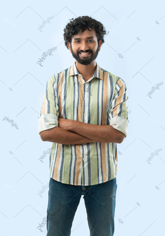 Happy young man with arms crossed