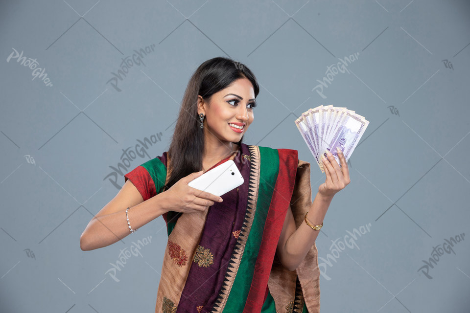 Happy young woman cashes out money