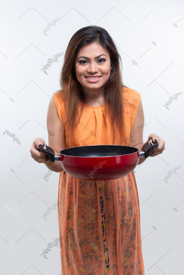 Happy young woman showing empty dish