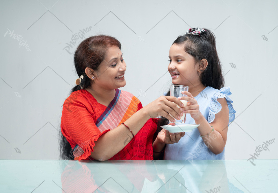 Health care Mother of Bangladesh giveing a glass of milk