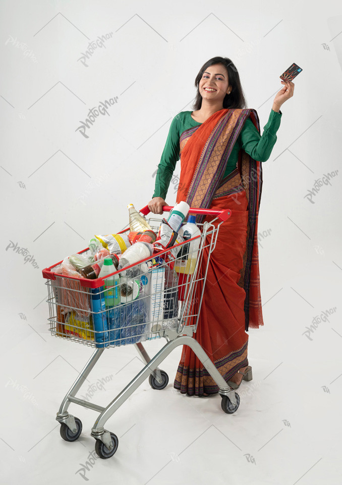 Housewife smiling and using credit card for payment