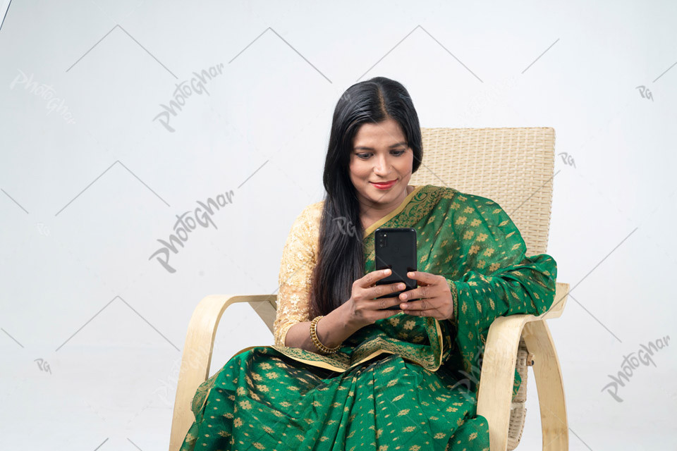 Housewife using mobile cell phone typing sms message