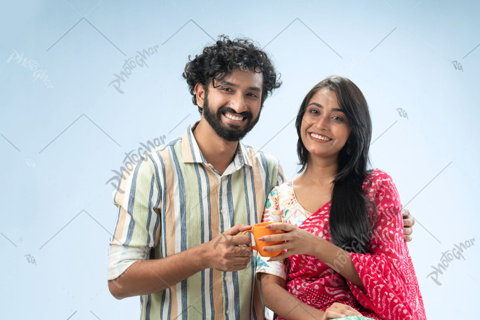 Joyful couple holding coffee mug