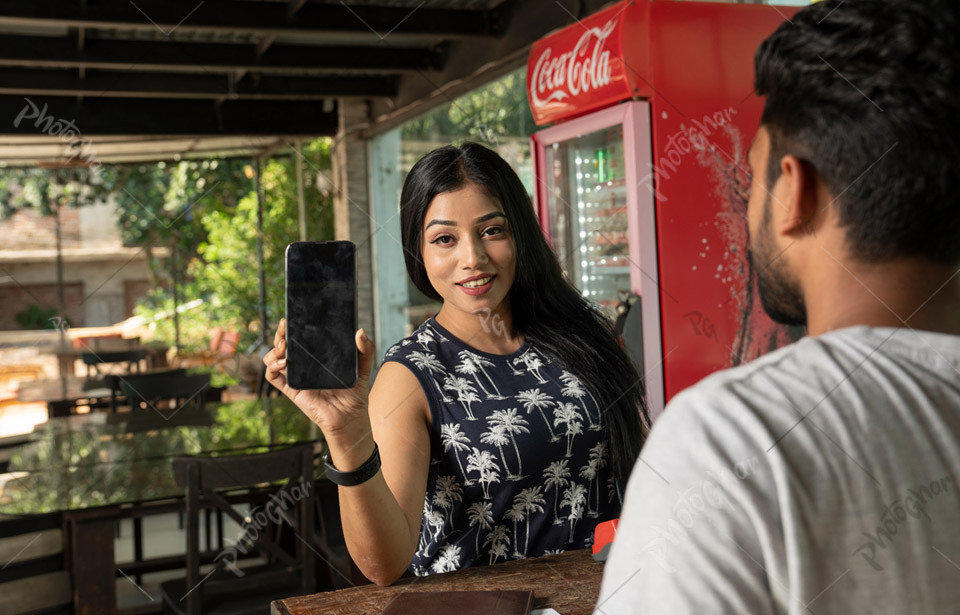 Joyful lady traveler showing smartphone screen