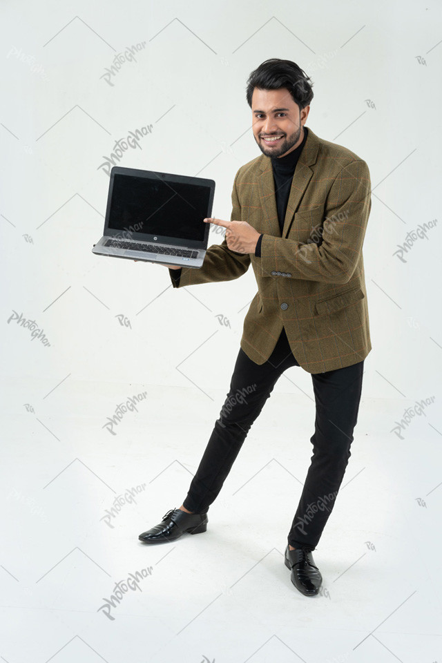 Joyful man pointing with computer