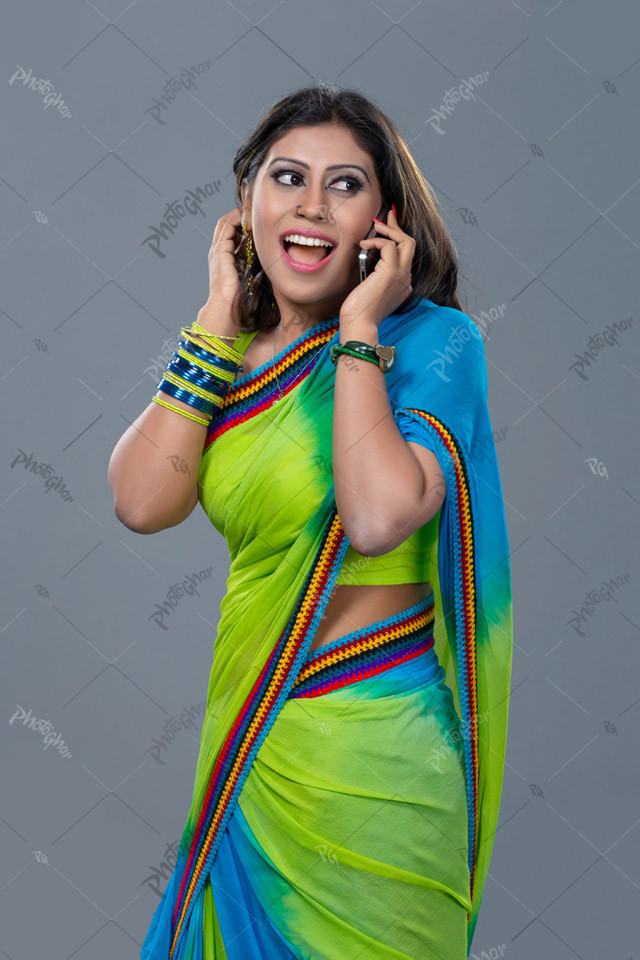 Joyful smiling housewife talking on smartphone