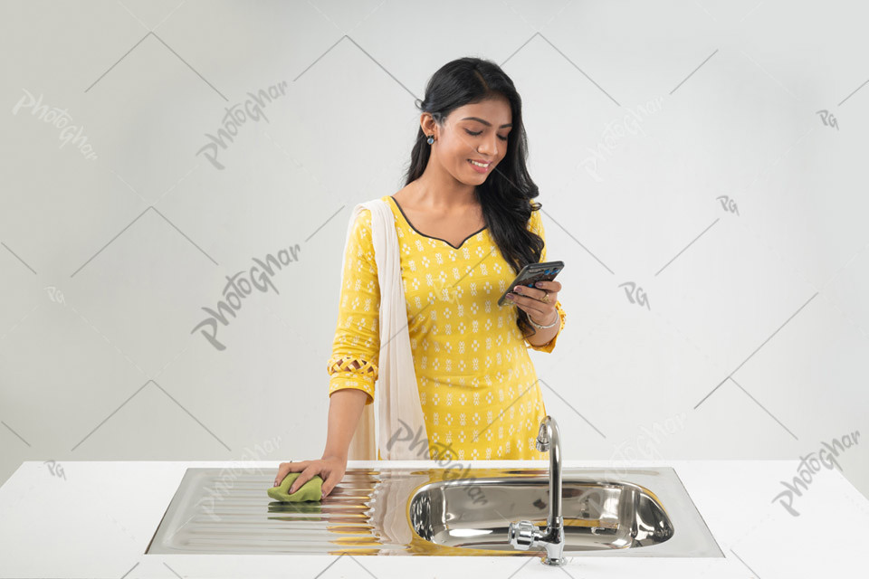 Joyful young housewife uses smartphone