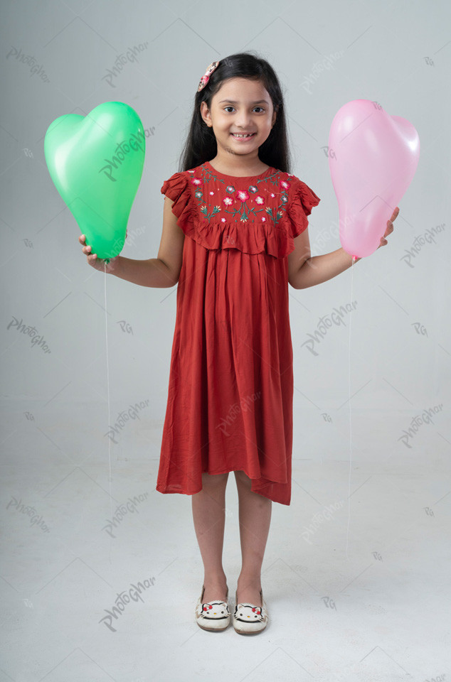 Little girl holding balloon