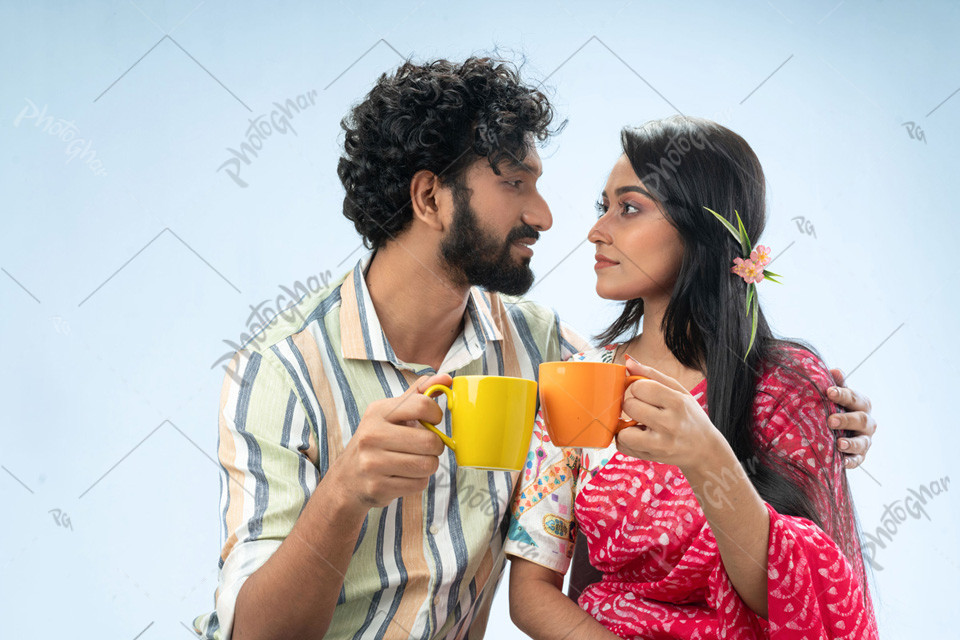 Loving cheerful happy couple holding coffee mugs