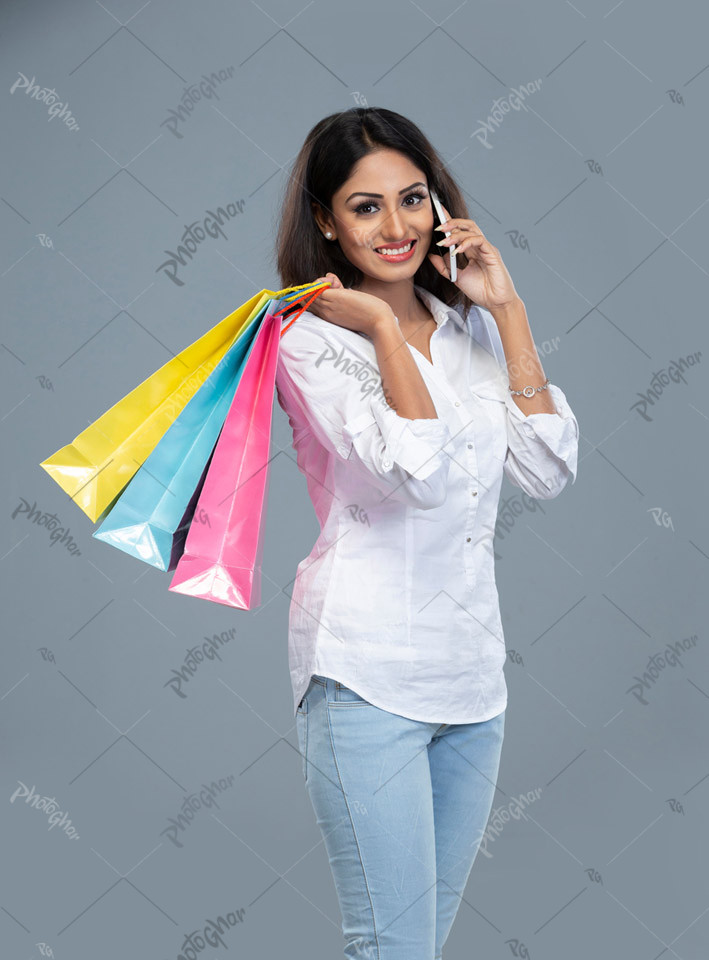 Modern woman talking with bags on shoulder