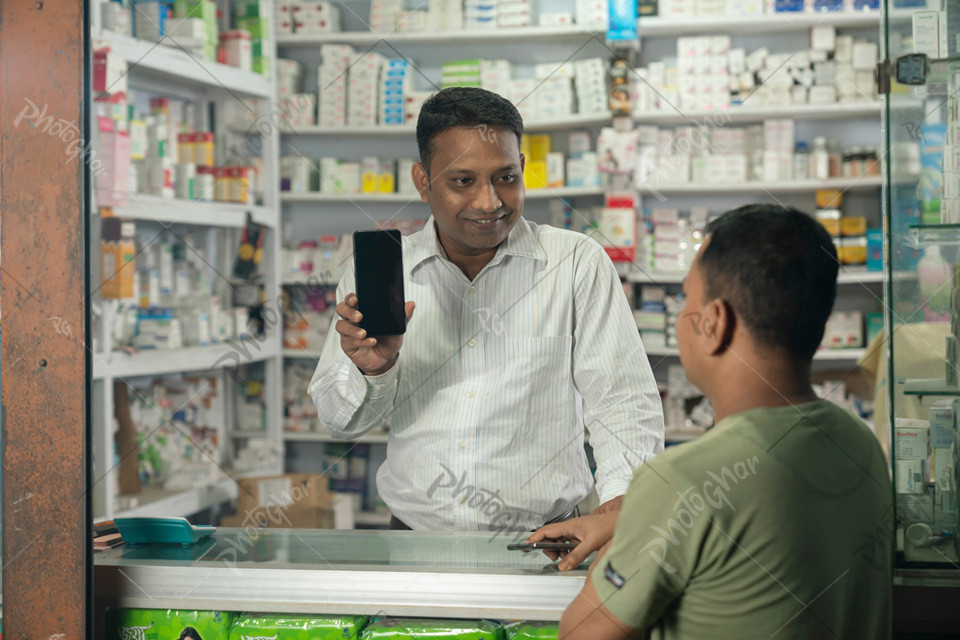 Pharmacist showing mobile apps to use online payment gateway