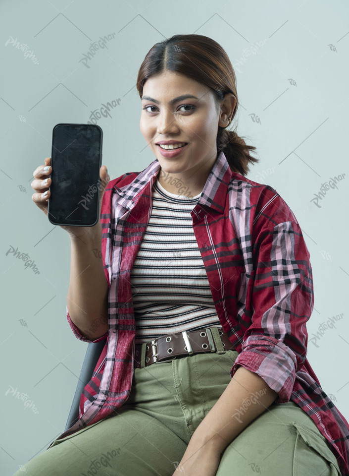 Pleased young female showing smartphone