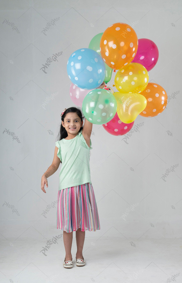 Portrait of cute child playing colorful balloon