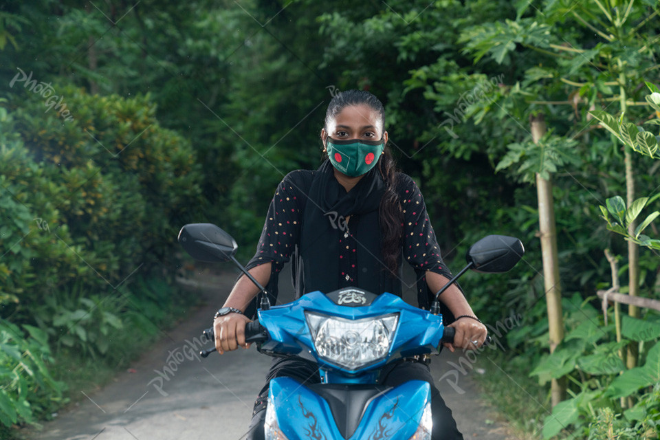 Portrait of village female riding scooty