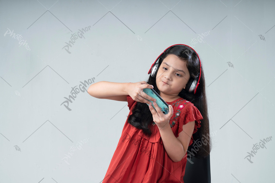 Portrait of young happy child using smart phone