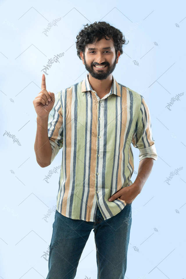 Positive cheerful youngster man pointing up