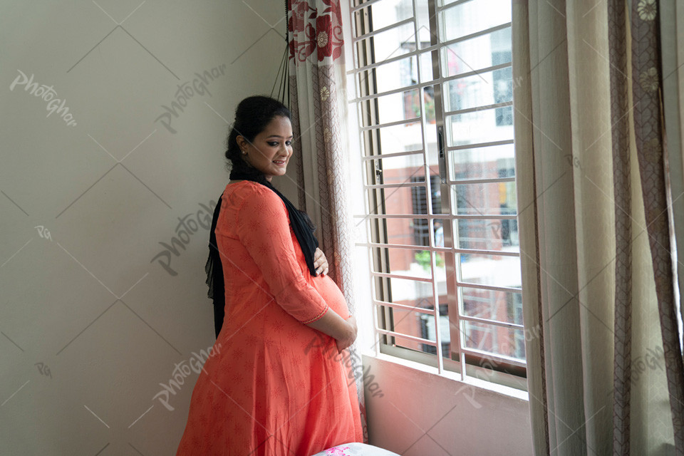 Pregnant woman in South Asia touching dreaming