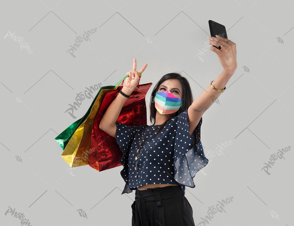 Protective mask woman showing victory sign