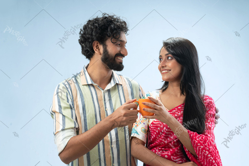 Romantic couple holding coffee mugs