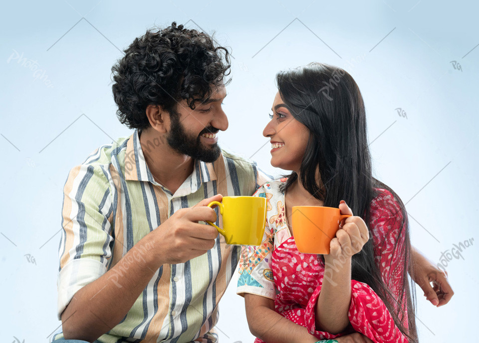 Romantic couple holding coffee mugs