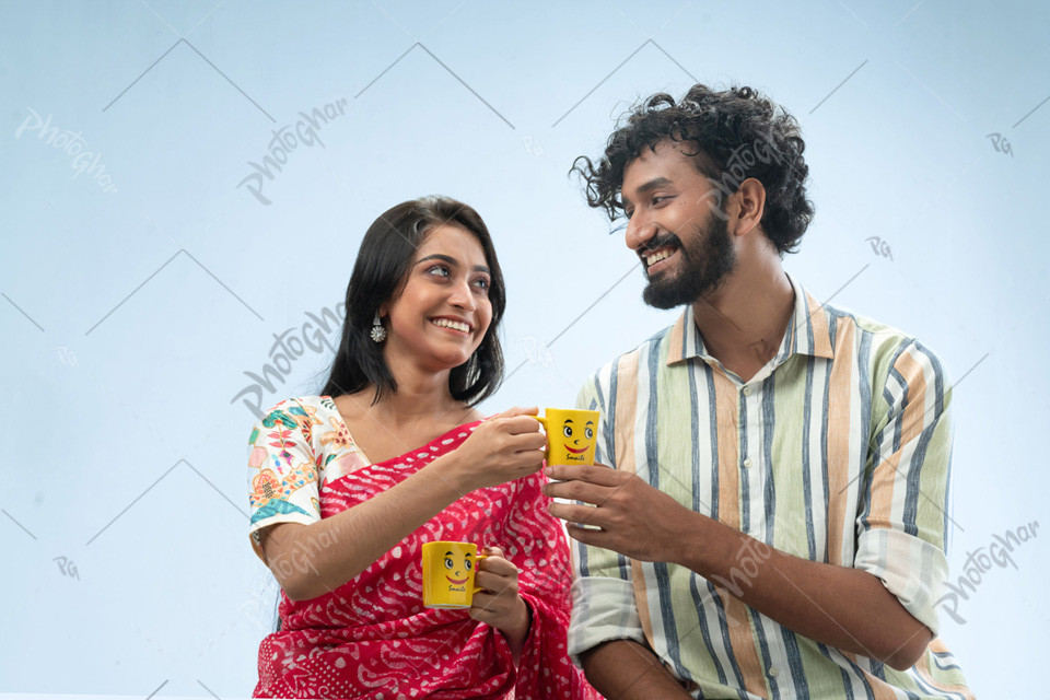 Romantic couple holding tea cups