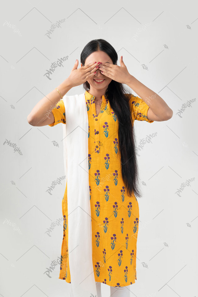 Smiling beautiful lady covering her eyes with hands