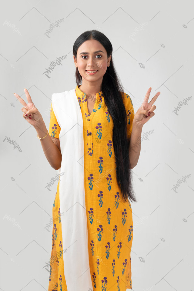 Smiling beautiful woman showing victory sign