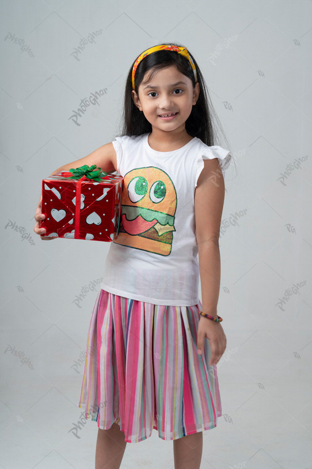 Smiling child of Bangladesh holding gift box