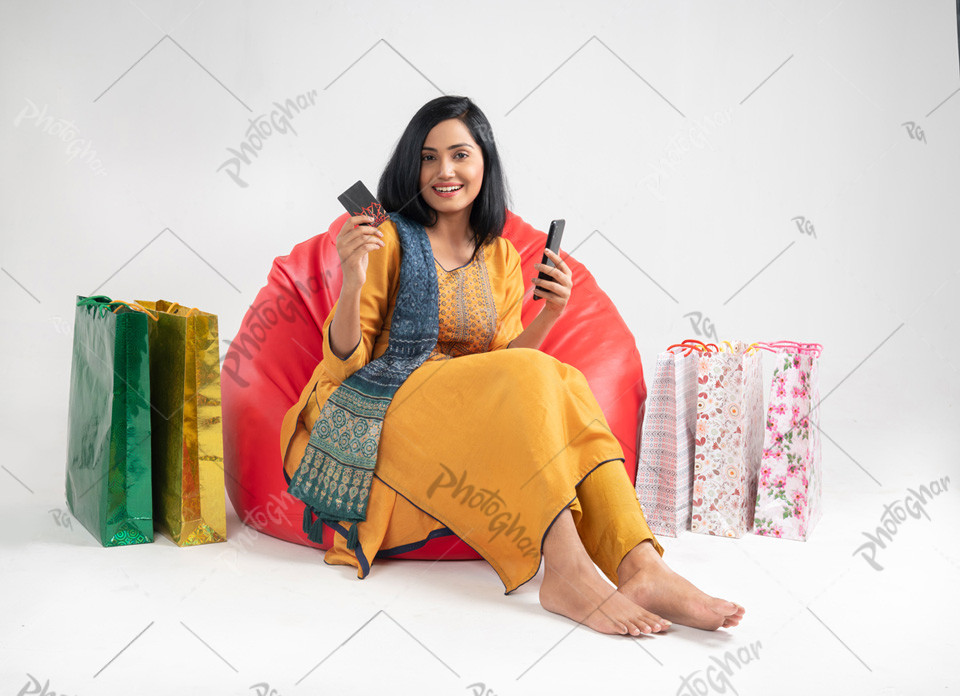 Smiling happy Customer using credit card holding mobile phone