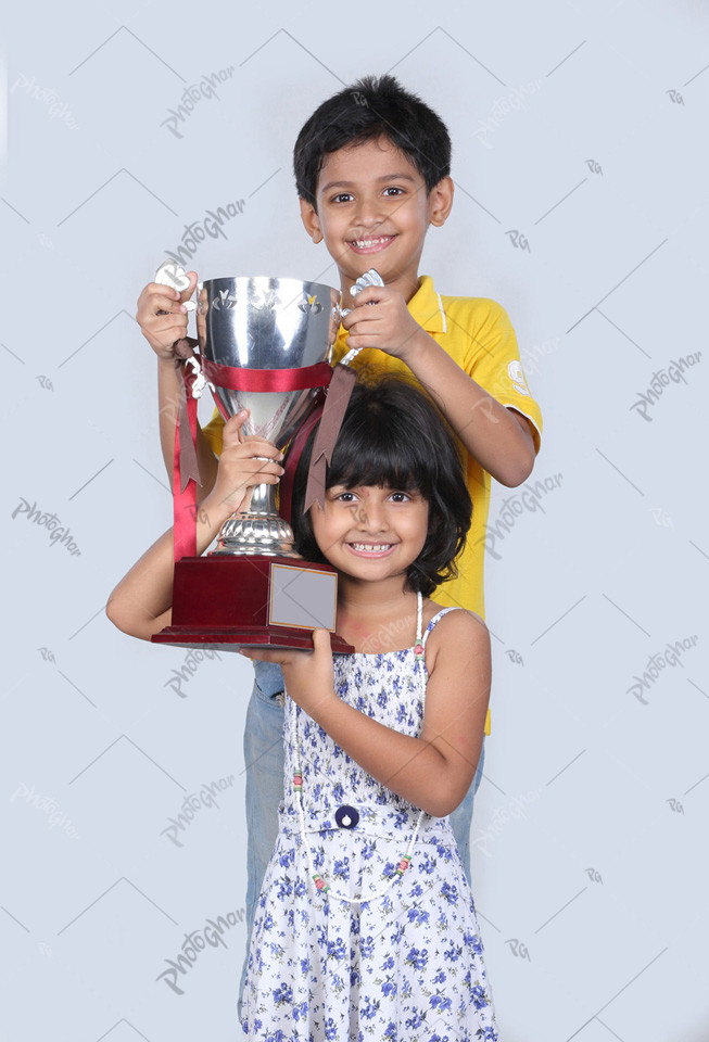 Smiling little children holding medal