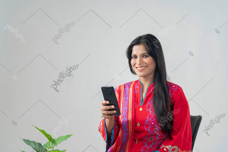 Smiling middle adult woman typing on cellphone