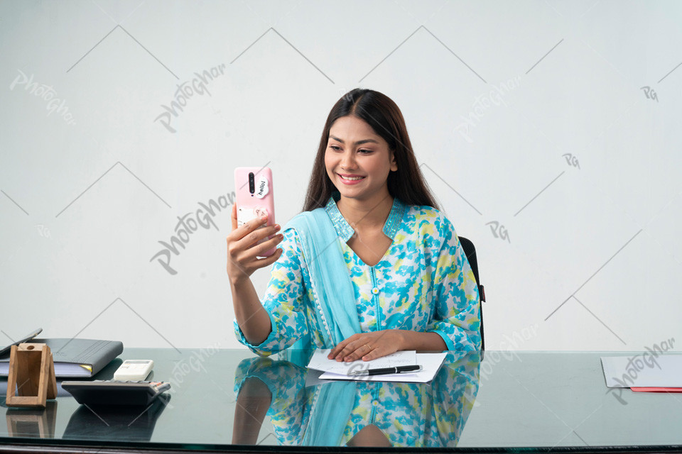 Smiling woman holding smartphone