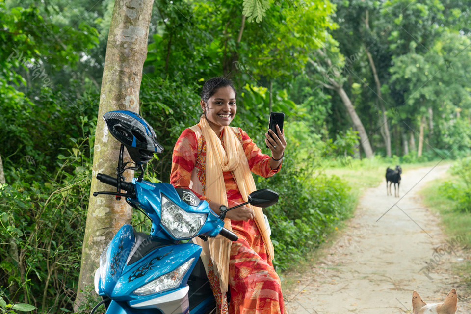 Smiling young girl talking video phone