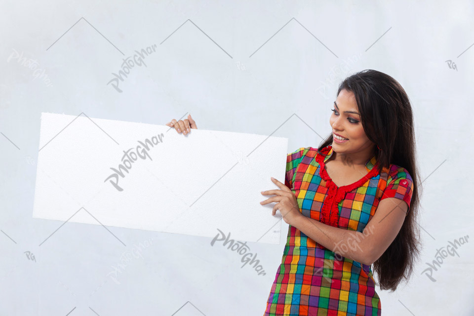 Smiling young lady holding blank placard