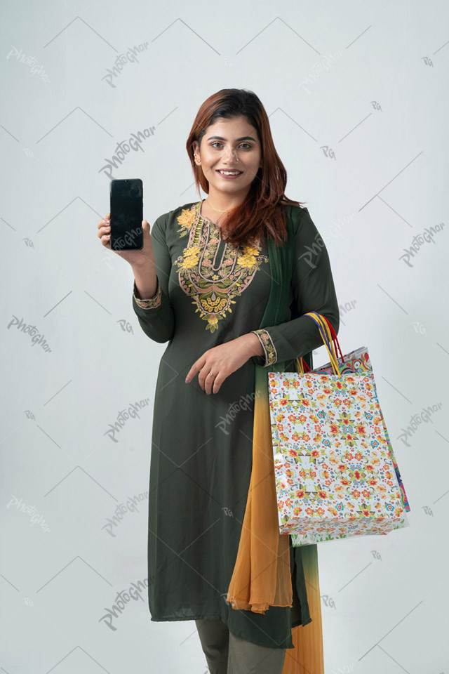 Smiling young lady showing discount offer on phone screen