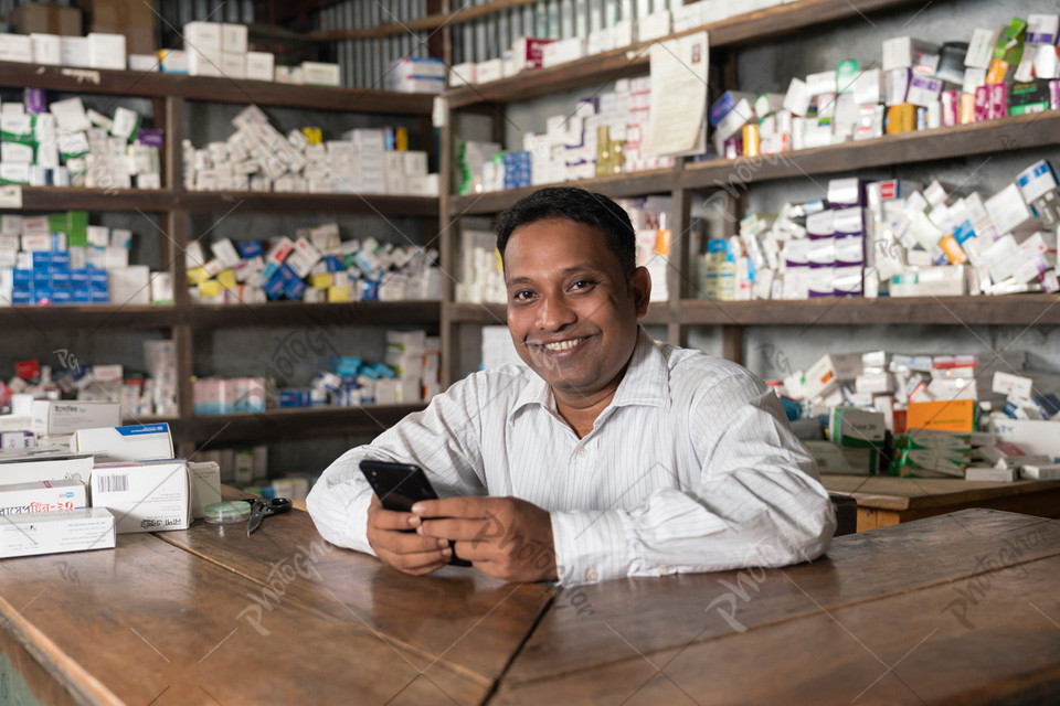 South Asian pharmacist checking online orders