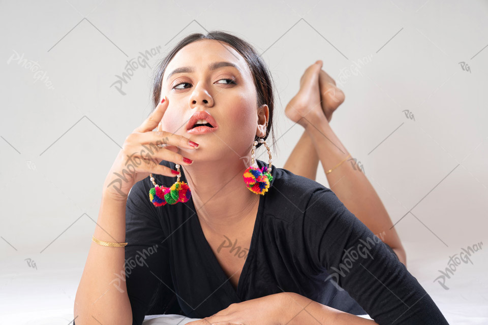 Stunning woman with radiant skin lying on bed