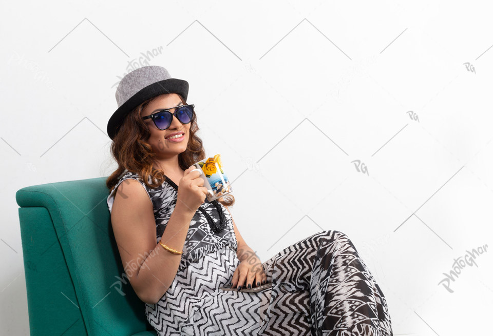 Stylish young lady holding coffee mug