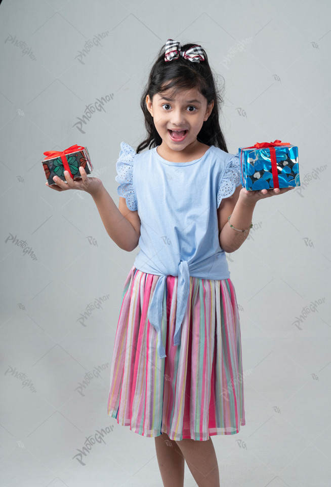 Surprised child holding gift boxs