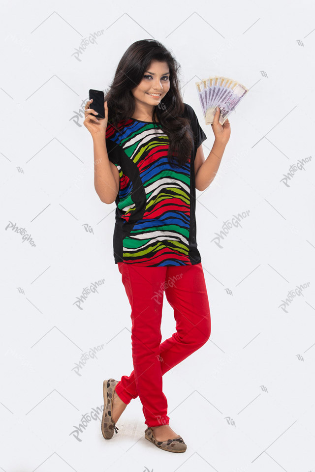 Teenage girl holding smartphone and taka banknotes