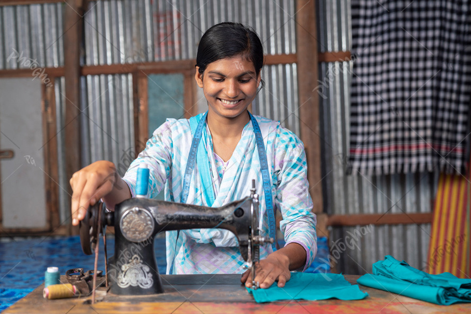 Teenager girl working with sewing machine