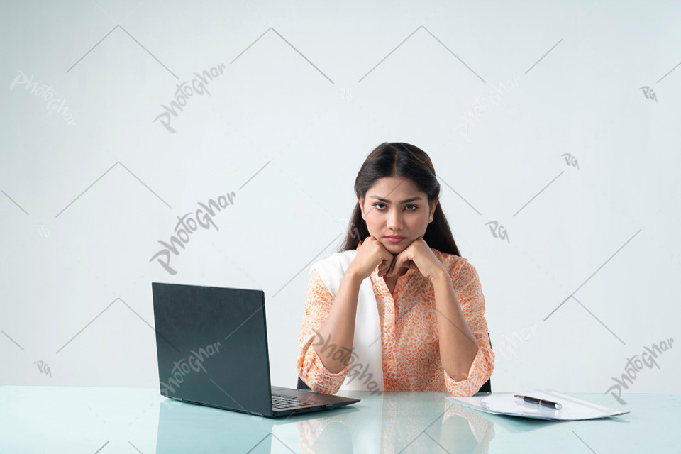 Unhappy woman sitting and using laptop