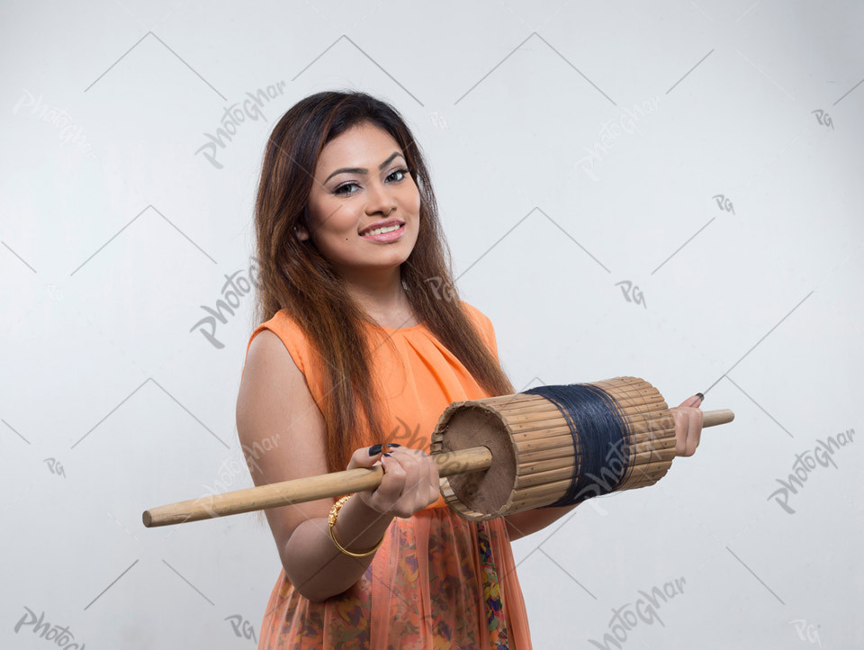 Woman flying kite holding a roll of thread