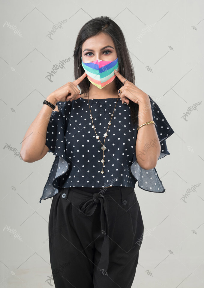 Woman pointing her mouth with protective mask