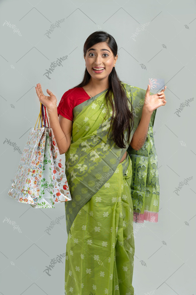 Woman showing card and carrying bags