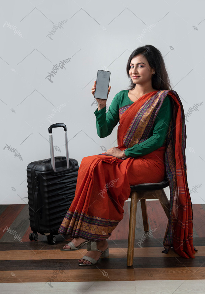 Woman shows her holding a smartphone, displaying an app