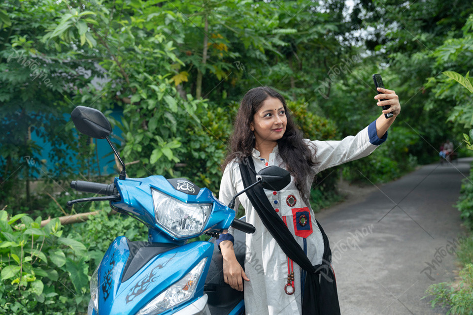 Woman standing beside Motorcycle