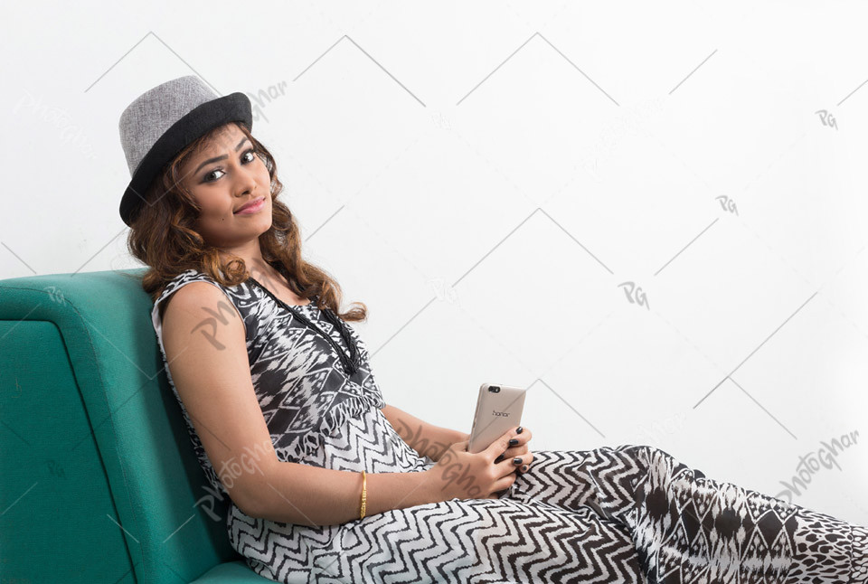 Wonderful woman traveler in hat, relaxing on sofa