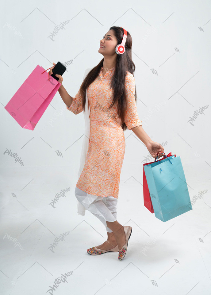 Young adult Bangladeshi lady walking happily