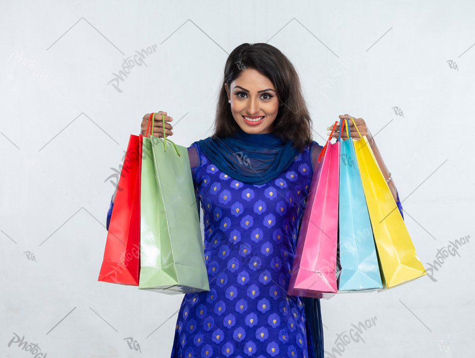 Young adult female holding shopping bags